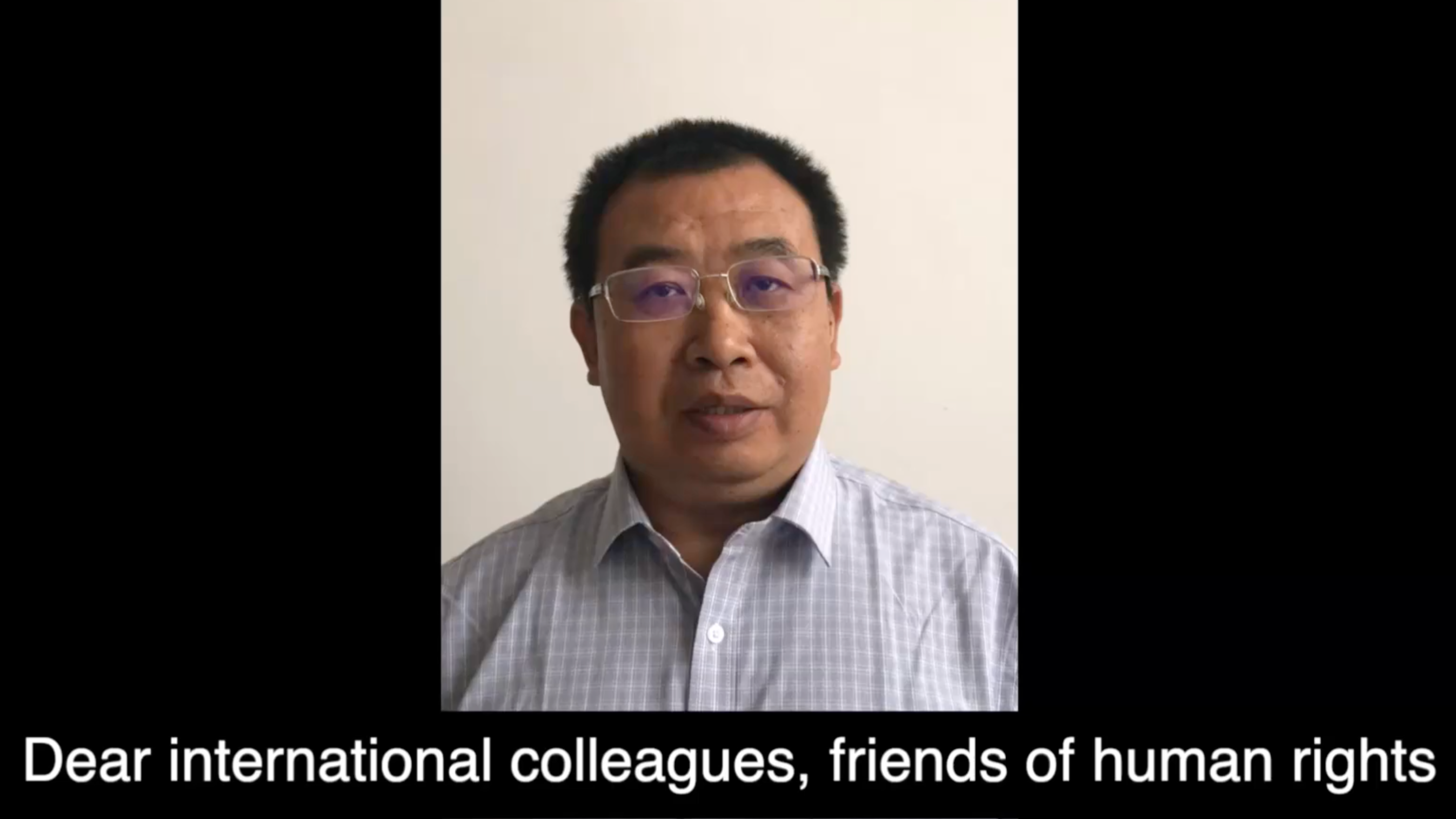 Jiang Tianyong in his home in China, saying "Dear international colleagues, friends of human rights" in his speech to accept his IBA award.