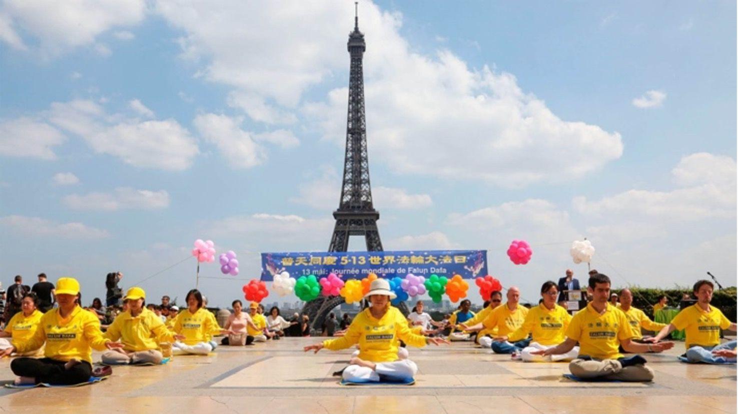 Falun Gong practitioners in Paris gather to meditate in front of the Eiffel Tower.