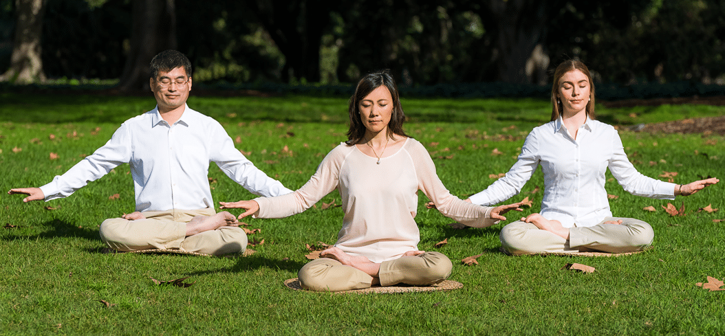 Three Falun Gong practitioners meditate the Fifth Exercise, a slow sitting meditation that averages one hour.